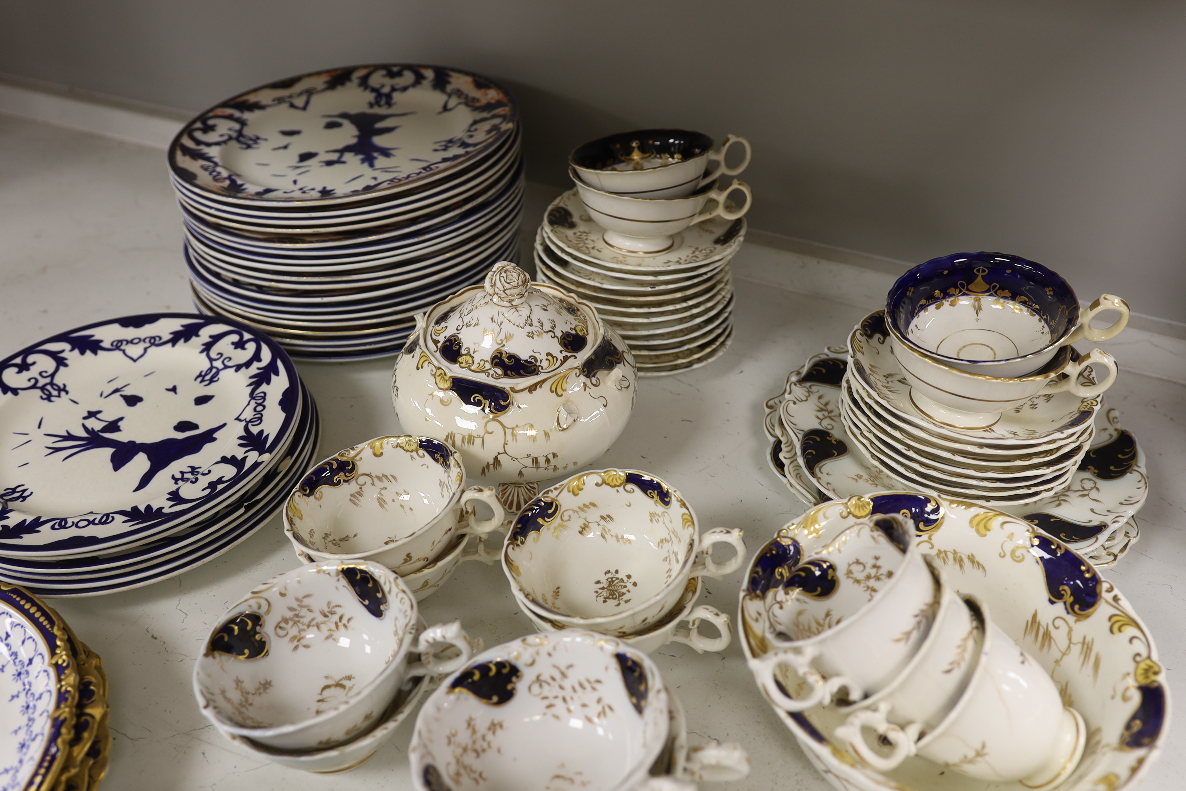 A Royal Crown Derby blue and gilt bordered part dessert service, together with a Victorian Staffordshire blue and gilt part tea service